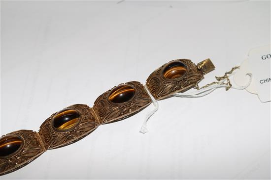 A Chinese silver gilt filligree and cabochon tigers eye quartz set bracelet, 73mm.